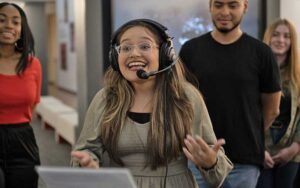 woman in headphones for dubbing demo at jesus film project tour