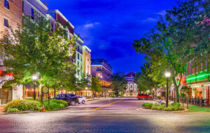 cobblestone downtown streets at night with colorful lighting and trees gainesville florida feature