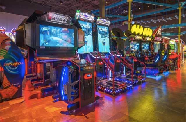 row of large shooter and racing arcade games at main event entertainment orlando