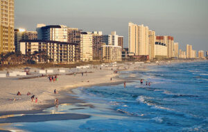 aerial view from surf of panama city beach with high rise hotels reflecting sun feature