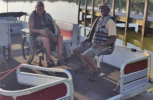 https://www.enjoyflorida.com/wp-content/uploads/2020/03/two-men-one-wheelchair-pontoon-ready-fish-memory-makin-fishing-guides-kissimmee.jpg
