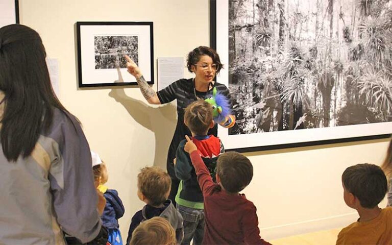 docent with puppet shows kids group photograph wall art at appleton museum of art ocala