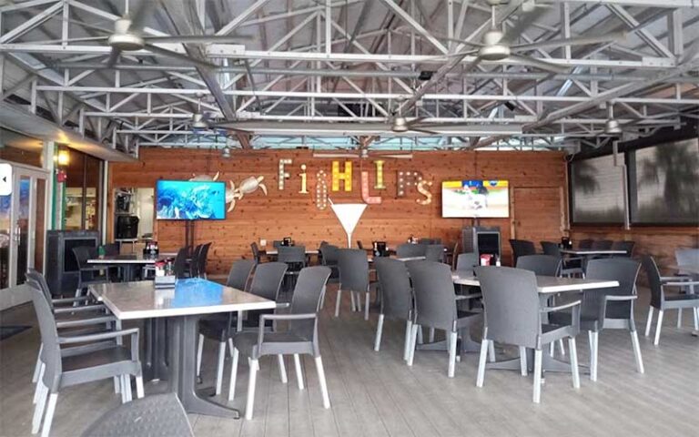 dining room interior with branded sign mural at fishlips waterfront bar grill port canaveral