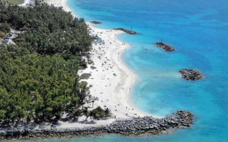 aerial view of beach with rock jetty and white sand at fort zachary taylor historic state park key west