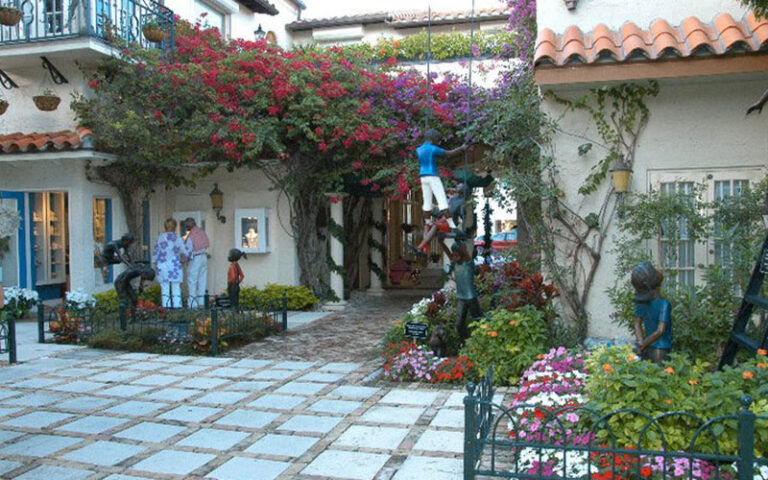 inside courtyard of shops with vines and stores at worth avenue palm beach