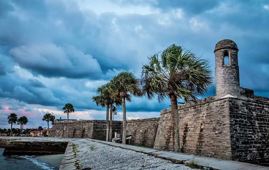 shoreline view of castillo de san marcos with dark storm clouds st augustine