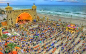 aerial view of amphitheater on beach at twilight with crowd and lights at daytona beach bandshell