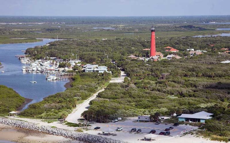 aerial view of coastal area with red lighthouse at ponce de leon inlet lighthouse museum daytona beach