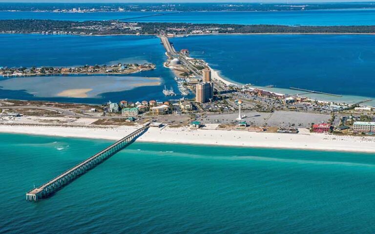 aerial view of coastline with bridge over inlet at pensacola beach