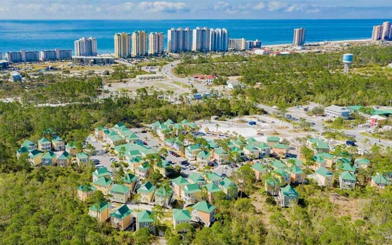 aerial view of yellow home rentals with beach in distance at purple parrot village resort perdido key pensacola