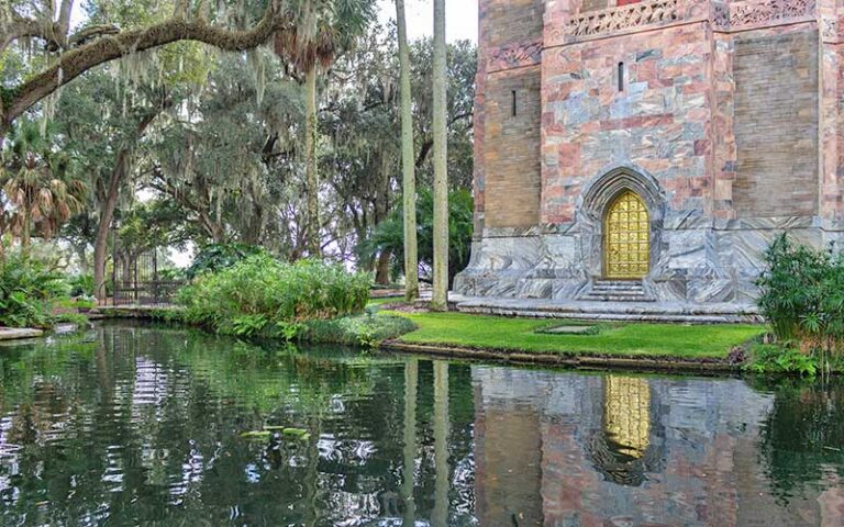 base of tower with brass door and reflective pool at bok tower gardens lake wales