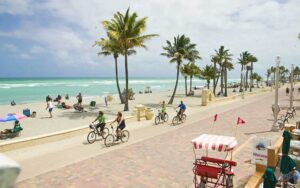 bikers and walkers on wide paved promenade along beach at hollywood beach broadwalk fort lauderdale