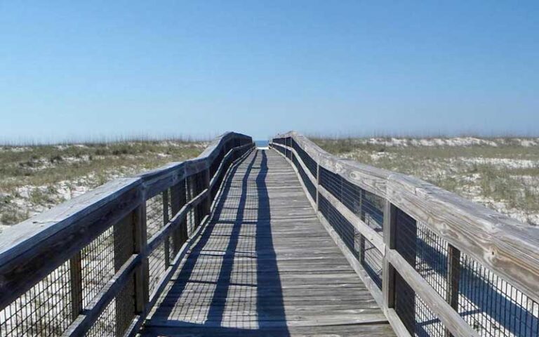 boardwalk over dunes with beach in distance at perdido key state park pensacola