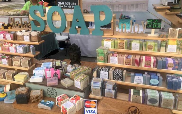 booth with handmade soap bars on wooden display at lakeland downtown farmers curb market