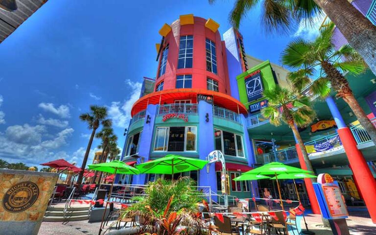 colorful multi story outdoor mall with patio seating sloppy joes and theater at ocean walk shoppes daytona beach