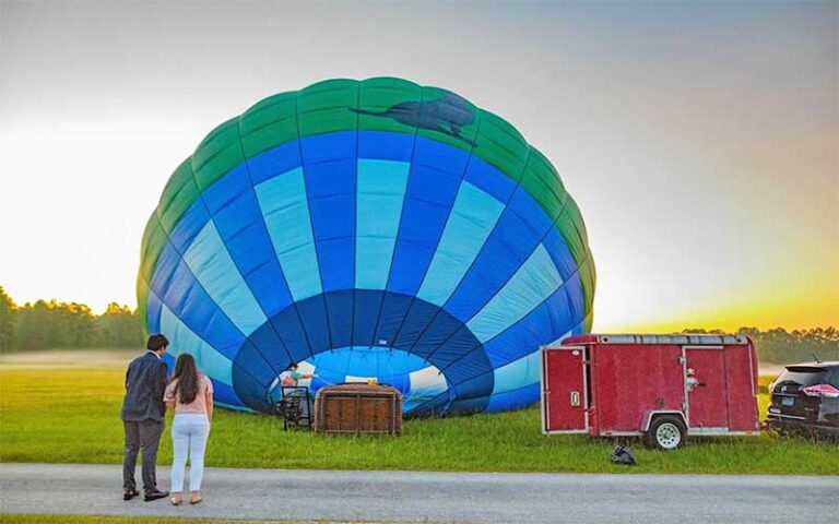 couple waiting for balloon to inflate with sun rising at air hound adventures davenport orlando