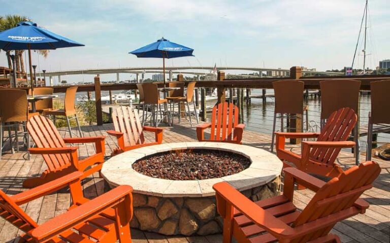 deck seating with fire pit and river view at caribbean jacks daytona beach