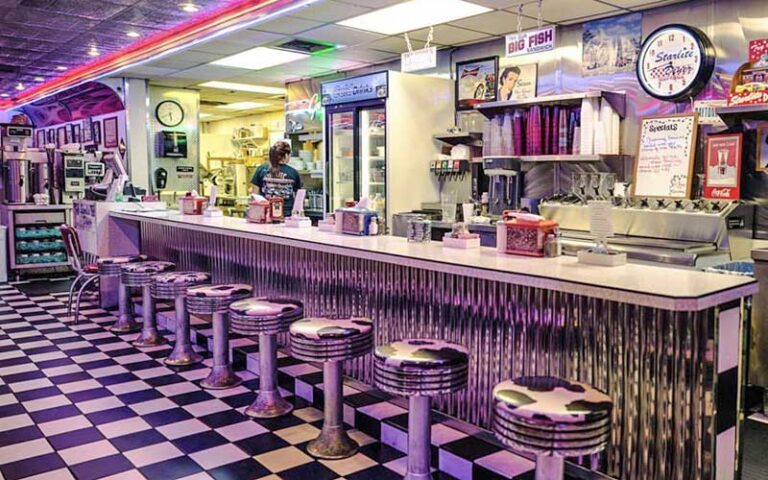 diner interior with retro chrome bar and server at starlite diner daytona beach