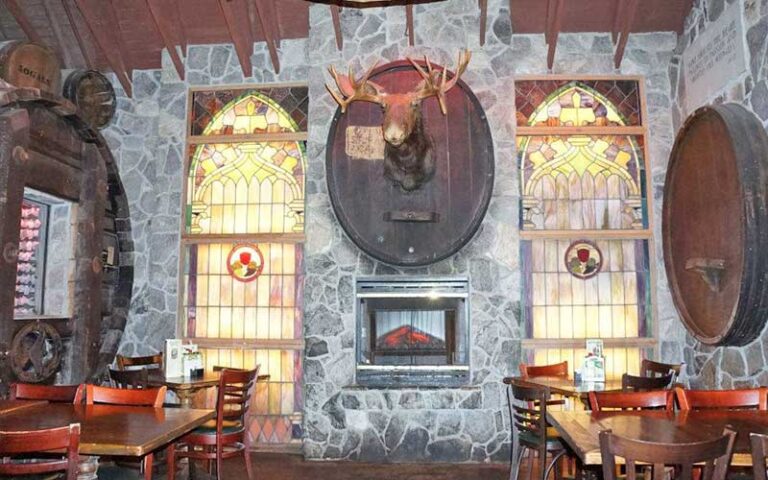 dining room area with fireplace and moose at mcguires irish pub pensacola
