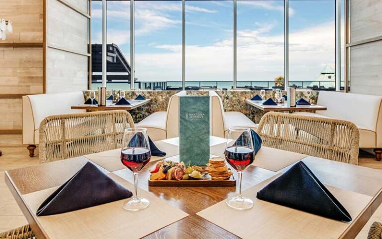 dining seating for two with wine and ocean view at daytona grande oceanfront hotel