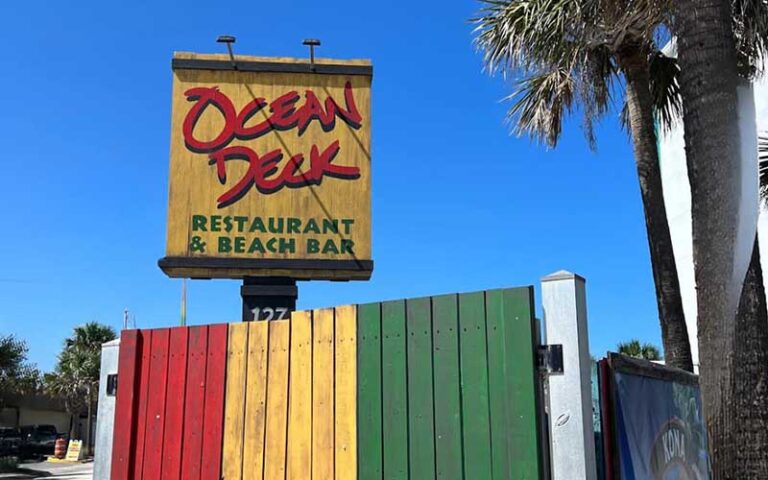 exterior of building with sign and colorful fence at ocean deck restaurant bar daytona beach