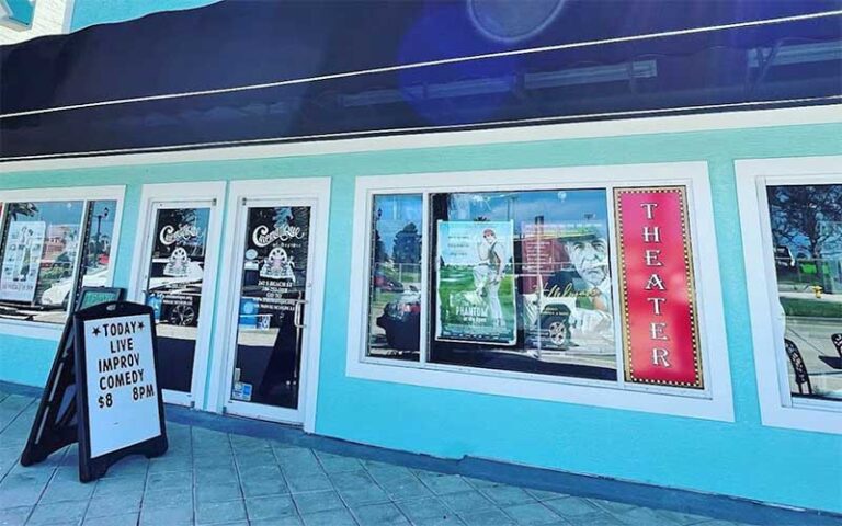 exterior store front theater with awning and signs at cinematique theater daytona beach