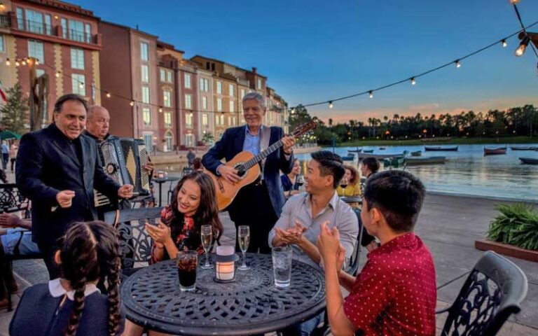 family dining on patio with live musicians and singer at loews portofino bay hotel universal orlando