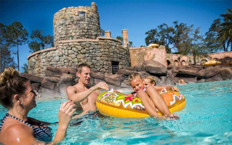 family swimming in pool with stone wall at loews portofino bay hotel universal orlando