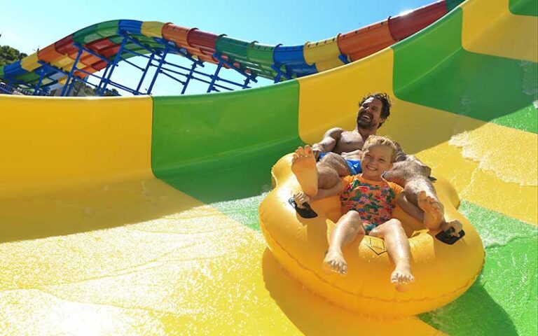 father and daughter riding tube down slide at daytona lagoon daytona beach