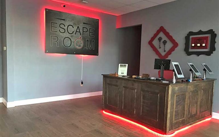 front desk with ipad kiosks and sign at lakeland escape room