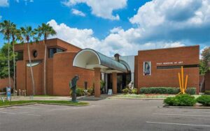 front exterior with sculpture and entrance at polk museum of art lakeland