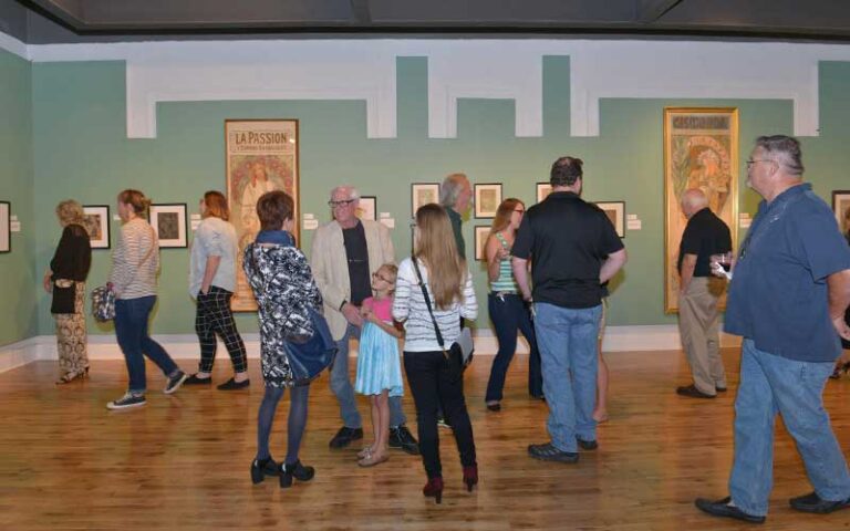 groups of patrons viewing art nouveau exhibit at pensacola museum of art