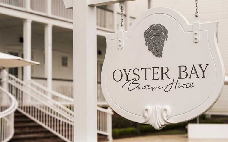 hanging shingle sign with hotel logo at oyster bay boutique hotel pensacola