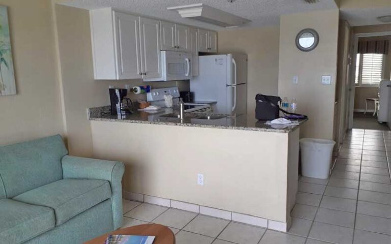hotel suite with kitchen and sofa at tropic shores resort daytona beach