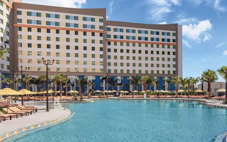 huge pool with loungers and hotel building at universals endless summer resort dockside inn suites orlando