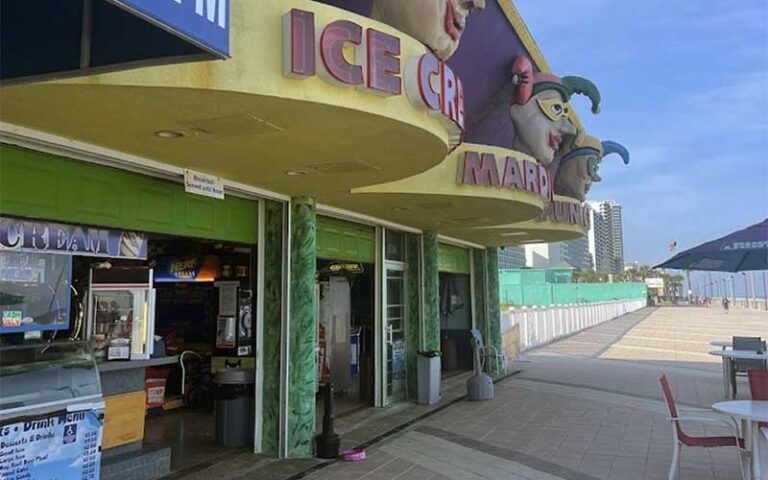 ice cream shop on boardwalk with jester figure signs at daytona beach boardwalk amusements