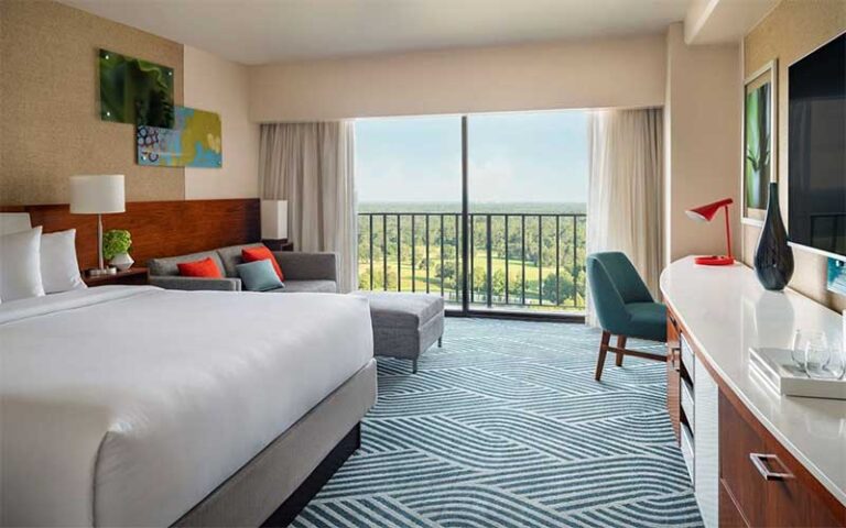 king size bed suite with balcony view at hyatt regency grand cypress resort orlando