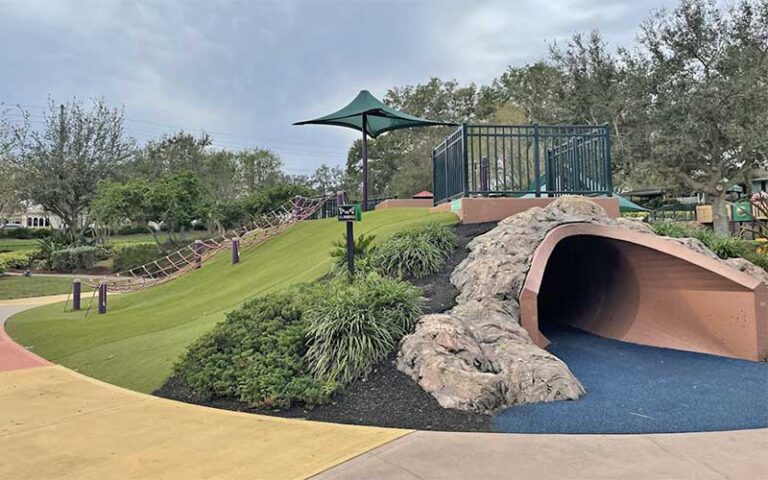 landscaped hill with tunnel in play area at common playground lakeland