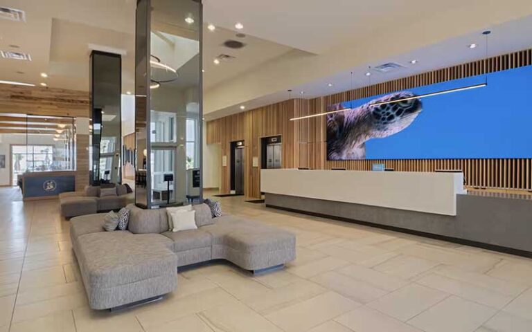 lobby of hotel with entrance and mirrored columns at hilton pensacola beach