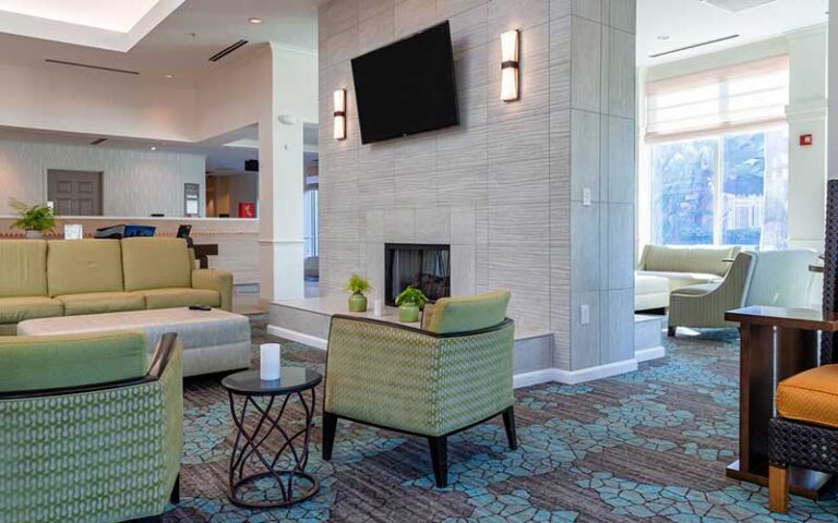 lobby seating with front desk and windows at hilton garden inn orlando east ucf area