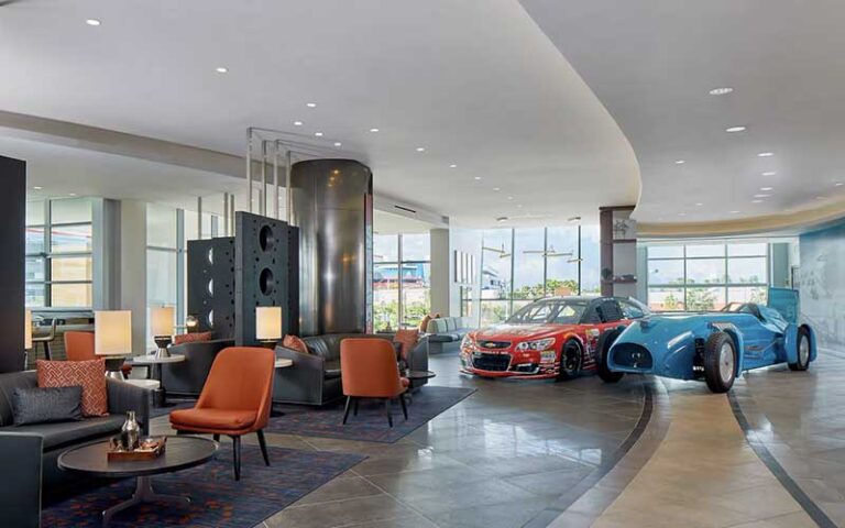 lobby with antique cars at the daytona autograph collection hotel