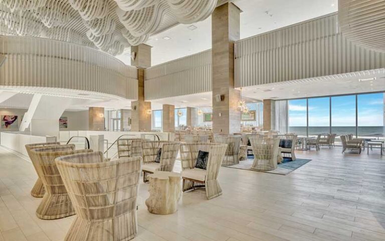 lobby with atrium and white wicker decor at daytona grande oceanfront hotel