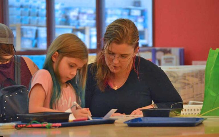 mom and daughter working on project at pensacola mess hall