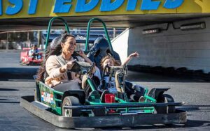 mom and kid in kart on track at fast eddies fun center pensacola