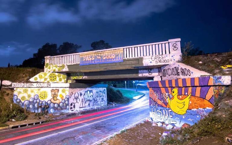 night view of underpass bridge with wall murals at graffiti bridge pensacola