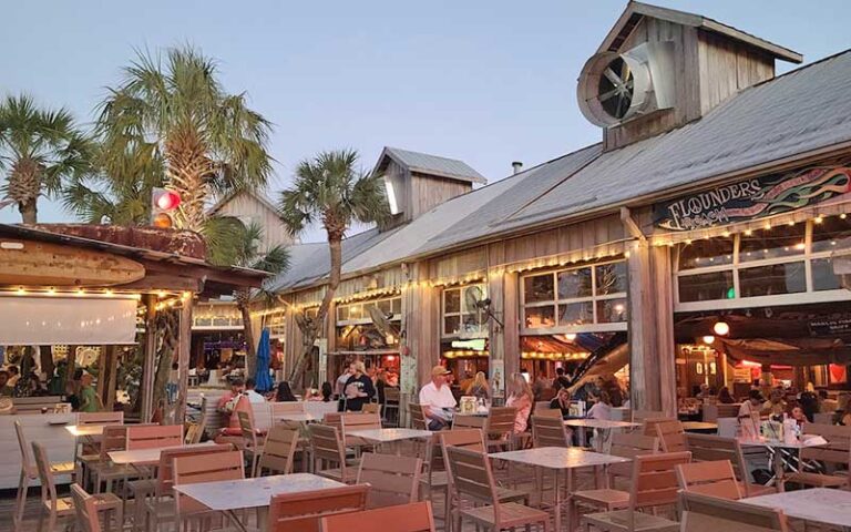 outdoor dining area on boardwalk at flounders chowder house pensacola beach