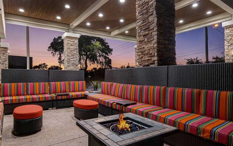 outdoor patio area with fire pit and stone columns at home2 suites by hilton gulf breeze pensacola area