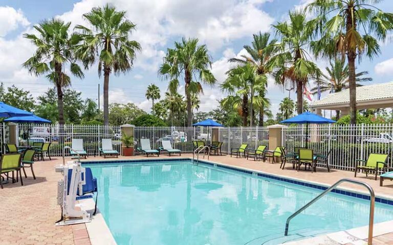 outdoor pool deck with ada lift and palms at hilton garden inn orlando east ucf area