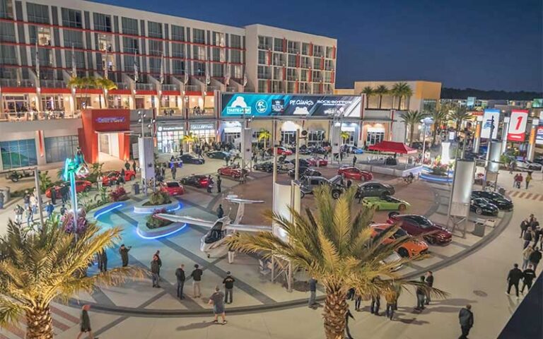 outdoor shopping plaza with car show at night at one daytona mall daytona beach