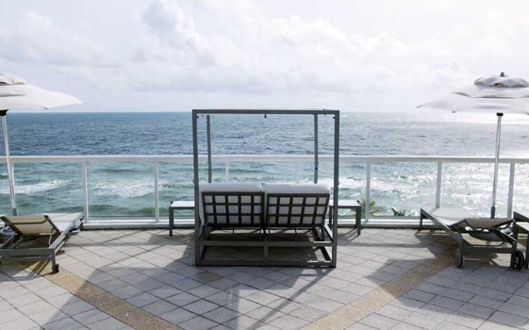 patio beach view with swing and loungers at hilton fort lauderdale beach resort